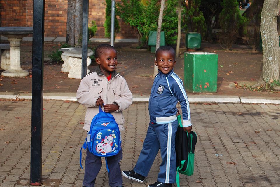 Two boys with their backpacks, going to school