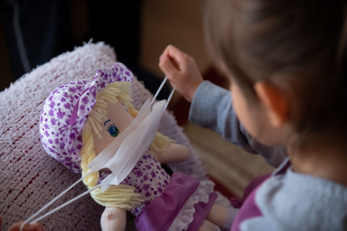 Child plays with doll during COVID-19