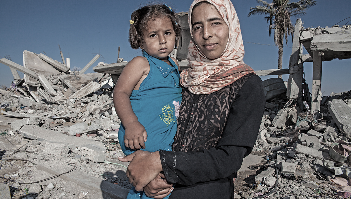 A child and her mother standing in front of their destroyed home in the Gaza Strip. Donate now, sponsor a child or sponsor a village to provide emergency relief through SOS Children