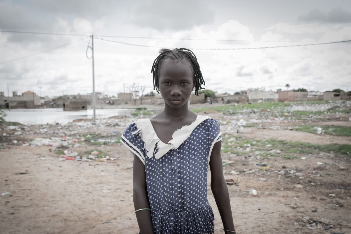 Child stands in her village in Senegal