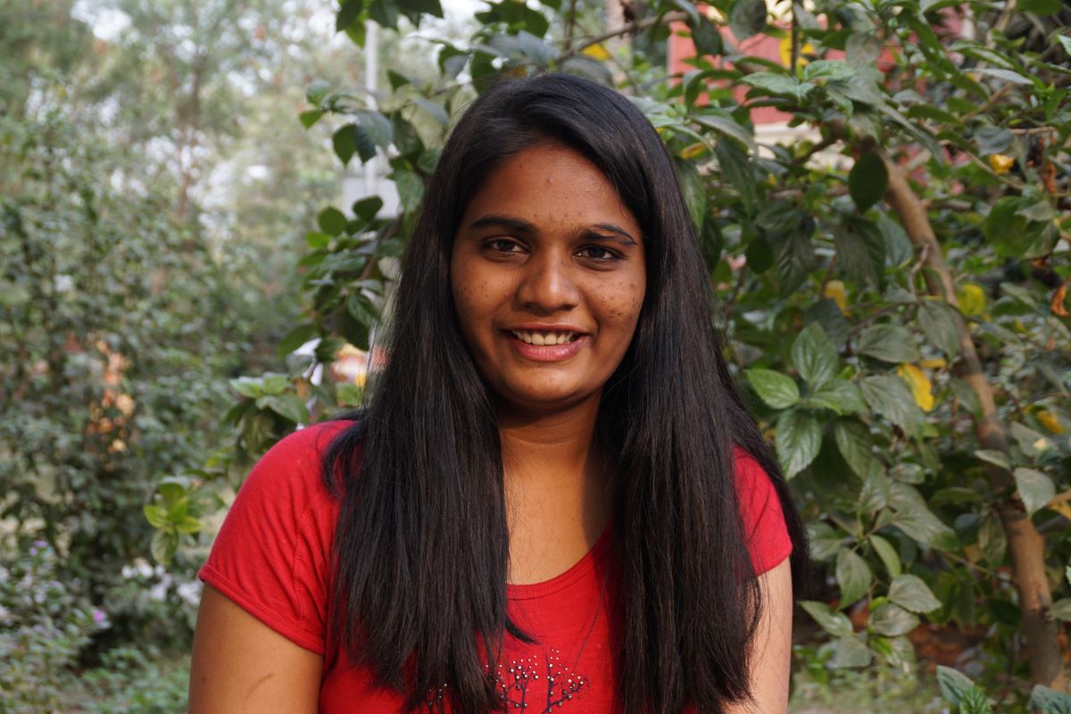 Mani smiling for a headshot