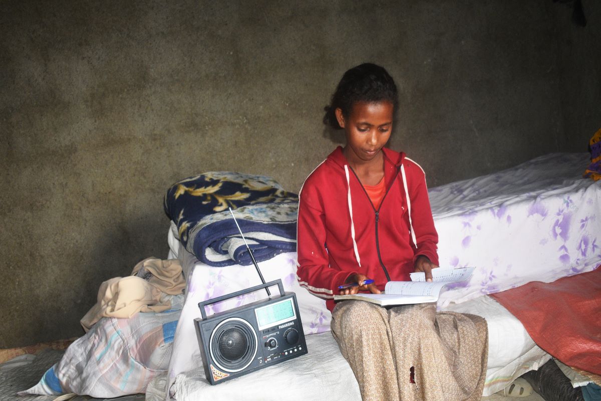 Child attends school at home by radio