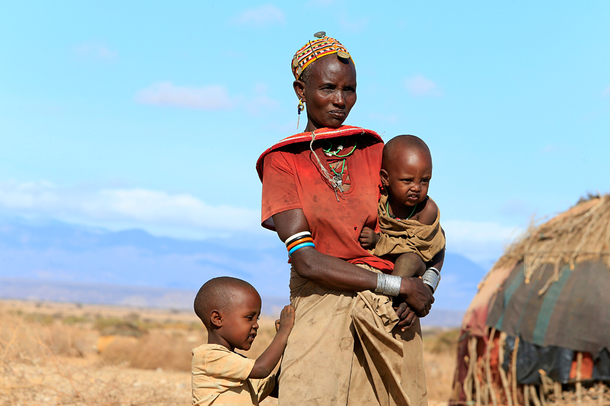 Nkatiye stands with her children in Kenya